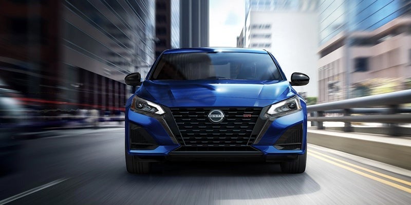 Front view of a Nissan Altima driving on city road