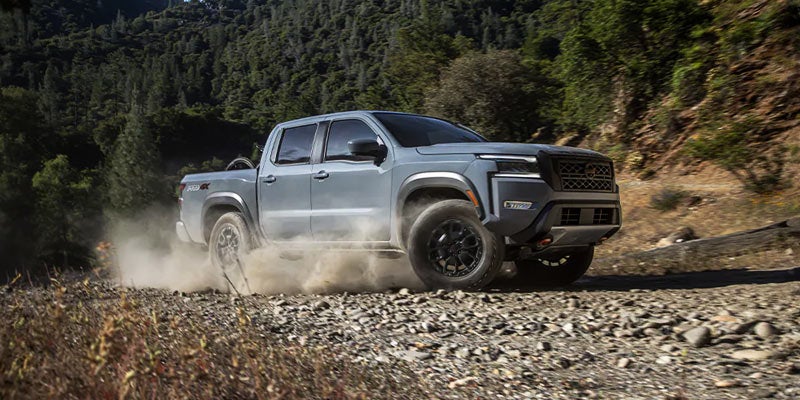 2024 Nissan Frontier driving on rocks making dust