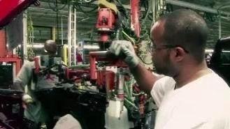 Men working a Nissan assembly line